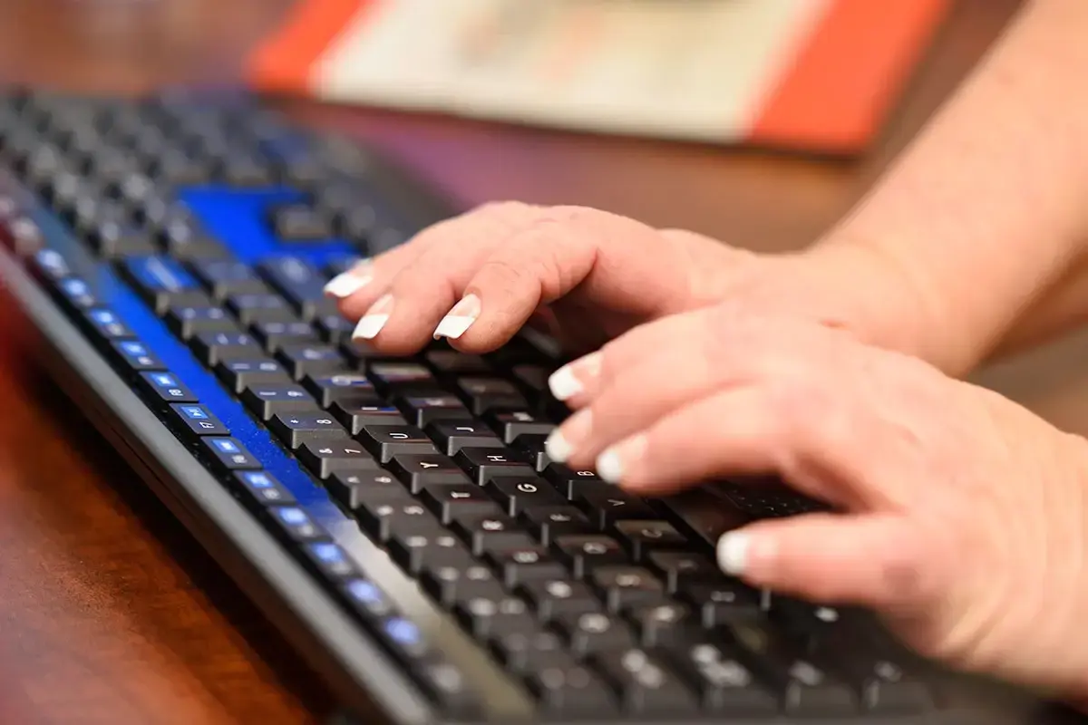 Woman typing on a keyboard